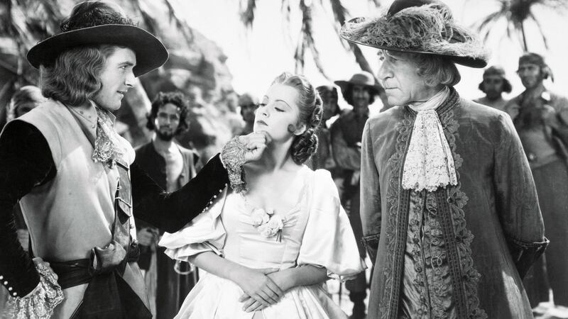 Olivia de Havilland with  Errol Flynn and Henry Stephenson in  Captain Blood, 1935. Photograph: Getty Images