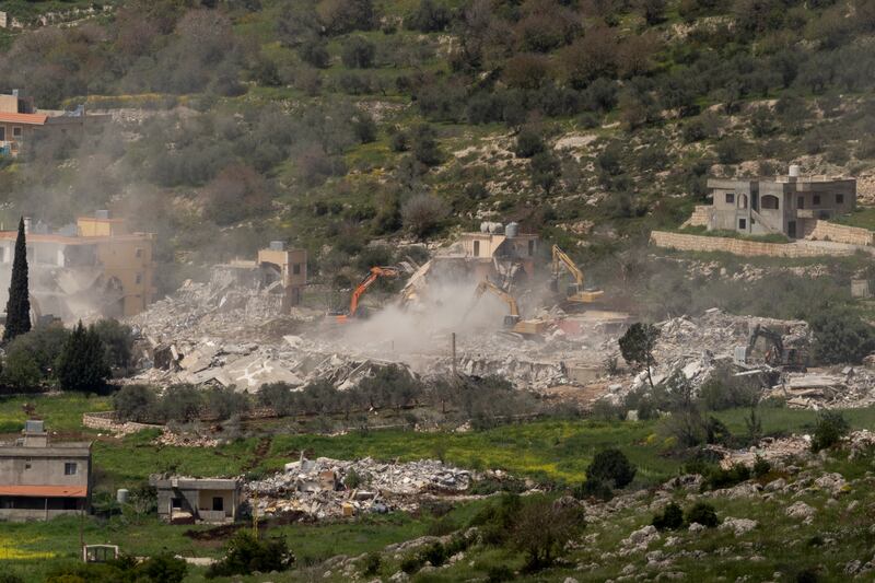 Israeli bulldozers demolish houses in Southern Lebanon, as seen from a position on the Israeli side of the border on April 12, 2026 in Southern Lebanon. Photograph: Amir Levy/Getty Images