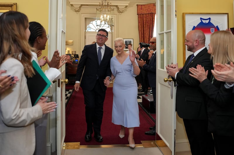 New British prime minister Andy Burnham and his wife Marie-France van Heel are welcomed by staff as they arrive inside 10 Downing Street. Photograph: Kin Cheung/Getty Images