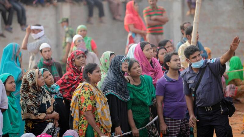 Crowds gather outside the collapsed Rana Plaza building  in Savar, outside Dhaka,  Bangladesh. Photograph: Andrew Biraj/Reuters