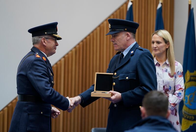 Garda Commissioner Drew Harris congratulates Garda Timothy McSweeney after he received a silver Scott medal from Minister for Justice Helen McEntee. Photograph: Niall Carson/PA Wire