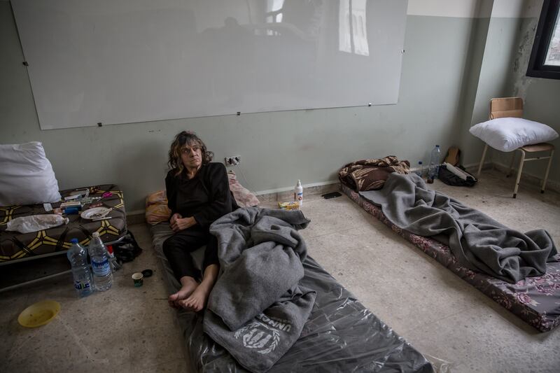 Ibtisam sits in the half of a classroom which she shares with her son in a shelter in Bir Hassan, greater Beirut. Photograph: Sally Hayden