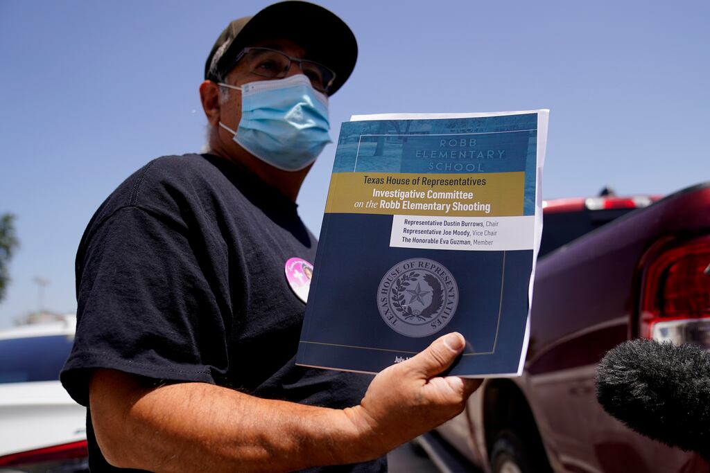 Vincent Salazar, grandfather of Layla Salazar who was killed in the shooting, holds a copy of the report. Photograph: Eric Gay/AP