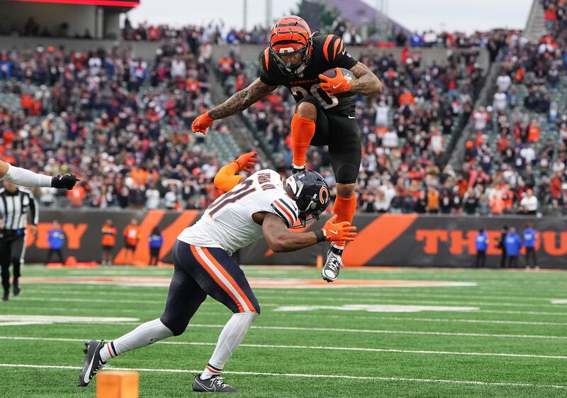 Chase Brown of the Cincinnati Bengals leaps over Kevin Byard III of the Chicago Bears. Photograph: Dylan Buell/Getty Images