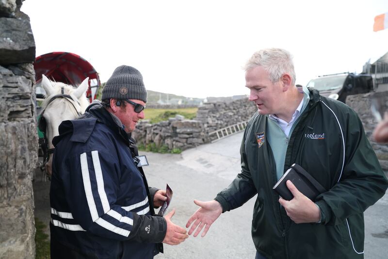Seán Kyne greets a potential voter on Inis Oírr.  Photograph: Enda O'Dowd