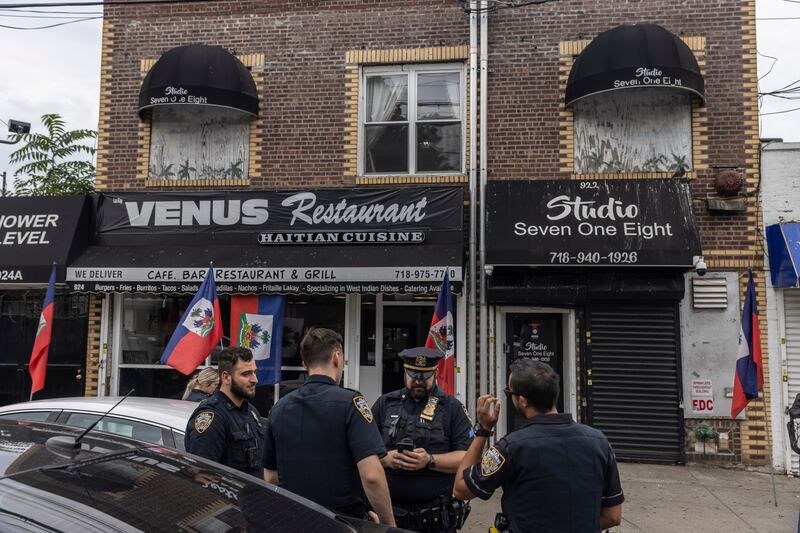 NYPD officers gather before Bishop Lamor Whitehead's news conference outside his church in Brooklyn, a humble space above a Haitian restaurant in Brooklyn. Photograph: Victor J Blue/The New York Times