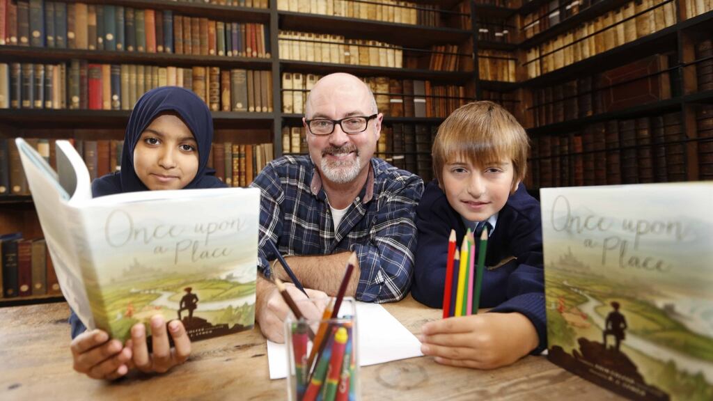 The new Laureate na nOg  PJ Lynch in  Marsh’s Library for the launch of Once upon a Place, which he illustrated and which was edited by his predecessor, Eoin Colfer,  with  Mekhy Amkhadov, left, and Maymoonah Elagrabi. Photography: Sasko Lazarov/Photocall Ireland