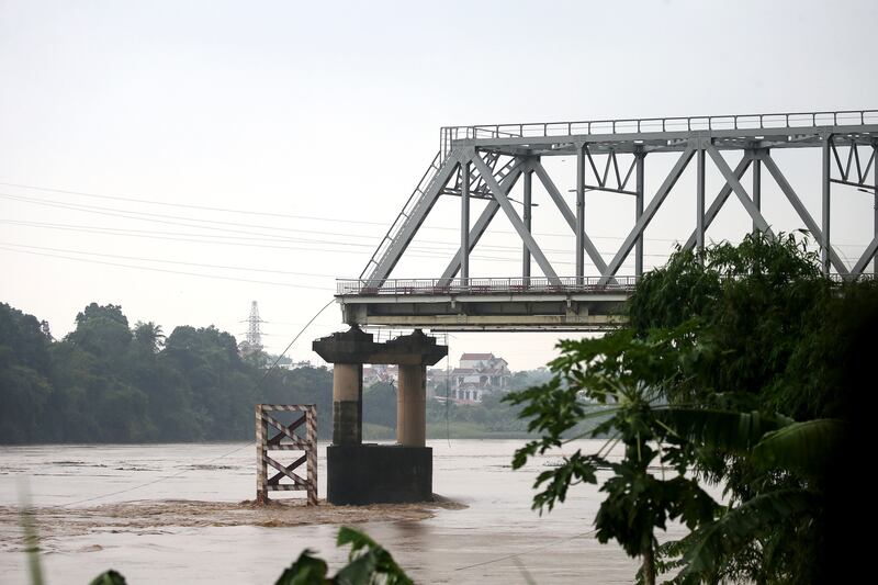 The remaining part of the Phong Chau bridge is still standing after its partial collapse into Red River, Phu Tho province, northern Vietnam. Photograph: Luong Thai Linh/EPA