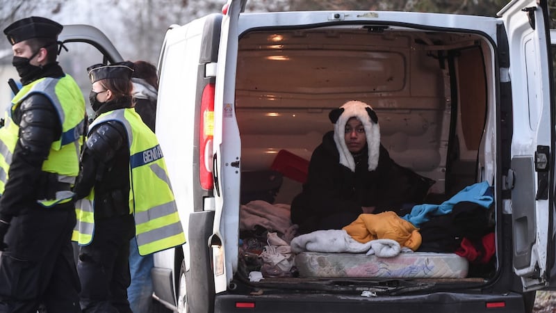 A reveller wearing a panda hat sits in the back of a van after being questioned by the French Gendarme following the break up of a rave. Photograph: Jean-Francois Monier/AFP/Getty