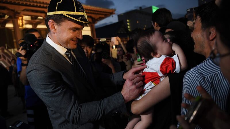 New Zealand’s Beauden Barrett signs autographs after a welcome ceremony at  in Tokyo. Photograph: Getty Images