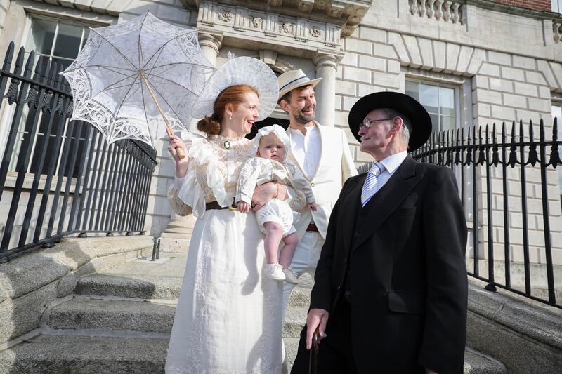 Raychel O’Connell and Johan Slattery with their son Tadhg (age 6 months) from Crumlin are greeted by James Joyce played by John Shevlin at Belvedere College, Dublin 1 for the traditional Bloomsday breakfast. Photograph: Conor McCabe Photography