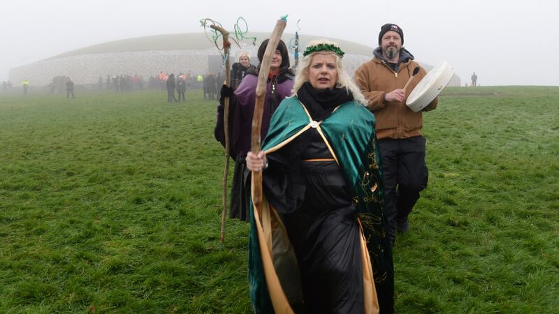 Bridget O’Brien, Ballinagore, Co. Westmeath,leads a group gathered outside the burial chamber at Newgrange in Co, Meath for the winter solstice. Photograph: Dara Mac Dónaill / The Irish Times