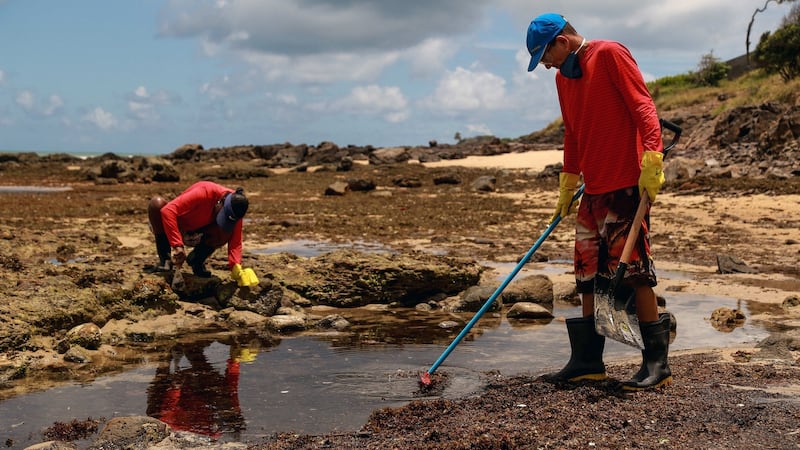 Volunteers help to clean up the oil sludge at the Itapuama beach, in Cabo de San Agostinho, Brazil. Photograph: EPA