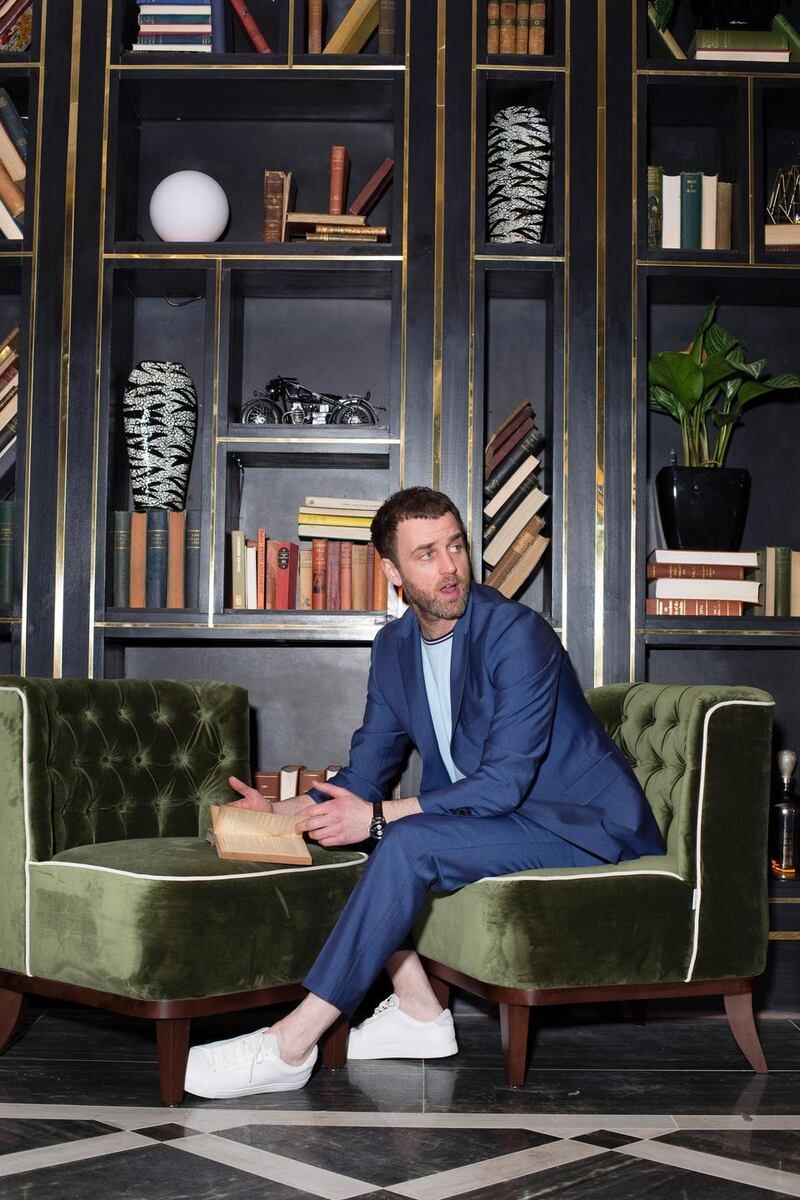 Blue suit  jacket €280, trousers €170, Richard James. Light blue Fred Perry T-shirt €50, Kurt Geiger trainers €110.