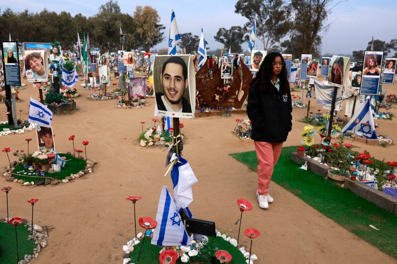 A woman walks past an installation on Thursday on the site of the Nova festival, in Re'im, southern Israel, bearing photographs of victims of the Hamas-led attack on October 7th, 2023. Photograph: Menahem Kahana/AFP via Getty Images