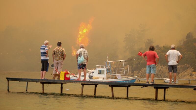 Tourists wait to be evacuated from the  smoke-engulfed Mazi area as wildfires rolled down the hill toward the seashore, in Bodrum, in Mugla, on Sunday. Photograph: Emre Tazegul/AP Photo
