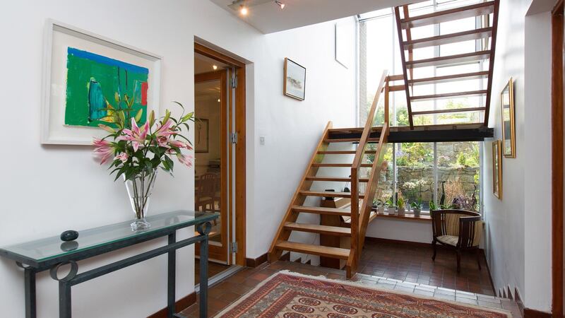The hall is particularly bright, with a window from the top to the bottom of the house  overlooking the rear garden