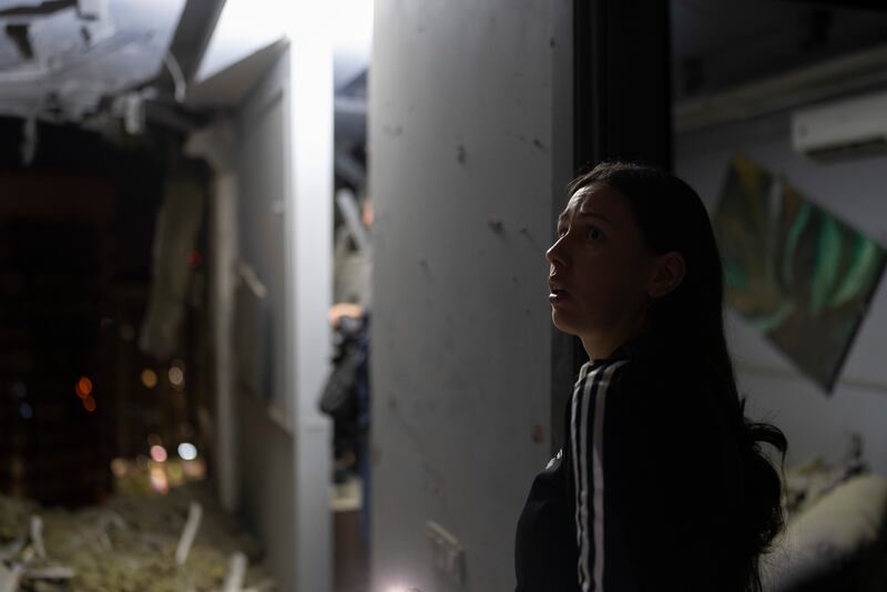 A resident surveys her neighbour’s apartment damaged in Russia’s air attack in Kyiv. Photograph: Jae C Hong/AP