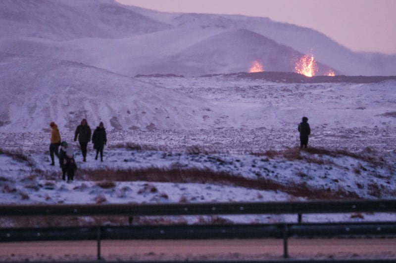 Onlookers watch lava bursting from the ground after a volcanic eruption near the town of Grindavik, Reykjanes peninsula, Iceland, on Tuesday. Photograph: Anton Brink/EPA