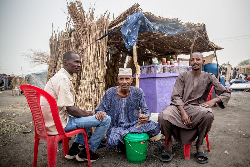 El Hadi Al Jeili, a 41-year-old farmer, pictured with two friends in a transit camp in Renk, South Sudan. Photograph: Sally Hayden