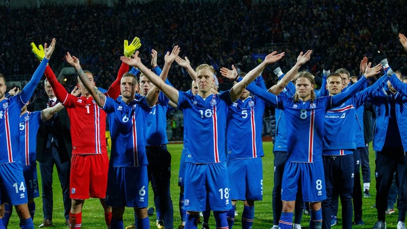 Iceland players do the now-famed ‘thunderclap routine’  with supporters after the victory over Kosovo in Reykjavik. Photograph: Birgir Thor Hardarson/EPA