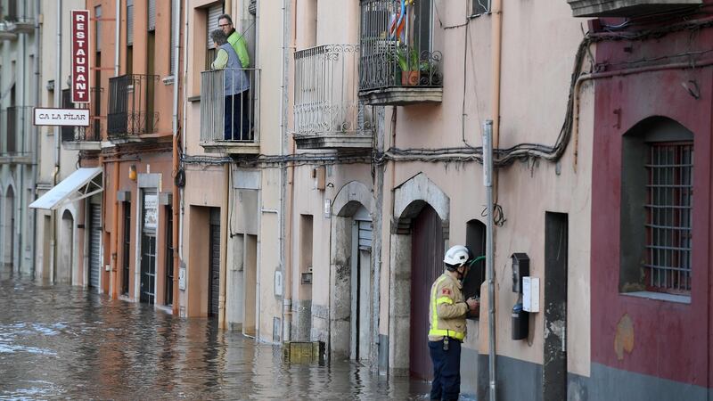 A fireman stands on a flooded street  in Sarria de Ter, Spain. Photograph: Josep Lago/AFP via Getty Images