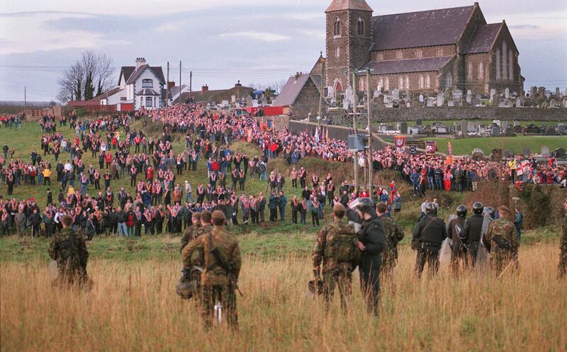 British Soldiers and RUC look on as Orangemen gather at Drumcree Church in Portadown in 1998. Photograph: Joe St Leger