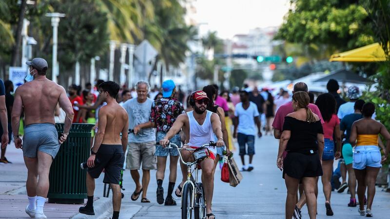 People cycling and  walking along Ocean Drive in Miami Beach, Florida in late June. Photograph: Chandan Khanna/AFP/Getty