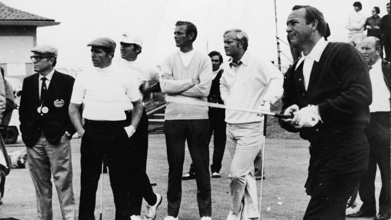 Arnold Palmer drives off of the first tee  during the 1970 British Open at St Andrews while Jack Nicklaus and Gary Player look on. Photograph:  Express Newspapers/Getty Images