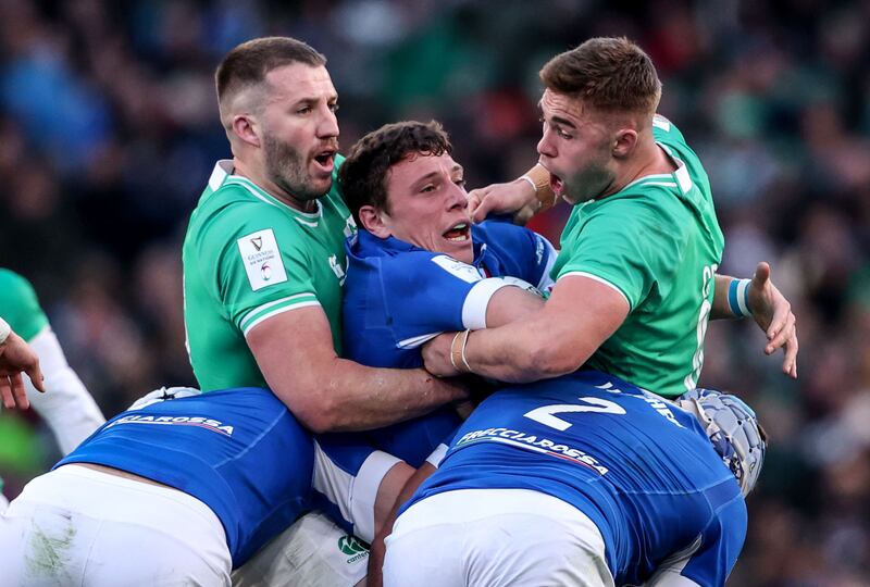 Stuart McCloskey and Jack Crowley hold up Paolo Garbisi during Ireland's win over Italy. Photograph: Dan Sheridan/Inpho