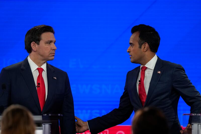 Republican presidential candidates businessman Vivek Ramaswamy, right, and Florida Gov. Ron DeSantis talk to each other during a commercial break in Wednesday's Republican presidential primary debate. Photograph: Gerald Herbert/AP Photo