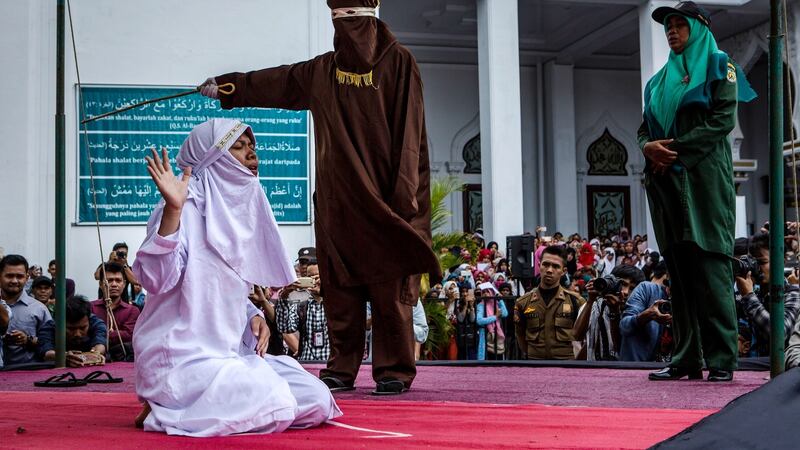 A  woman is caned in public for spending time with a man who is not her husband, which is against Sharia law, at Syuhada mosque in Banda Aceh, Indonesia. Photograph:   Ulet Ifansasti/Getty Images