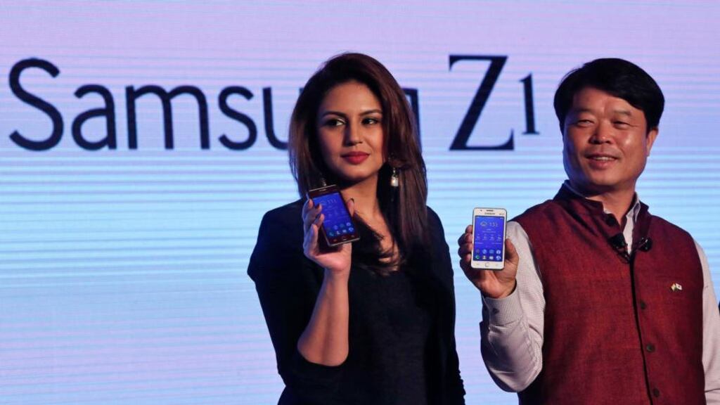 President of Samsung India Electronics Hyun Chil Hong and and Bollywood actress Huma Qureshi with the new Tizen-powered Z1 at its launch in New Delhi. Photograph: Reuters