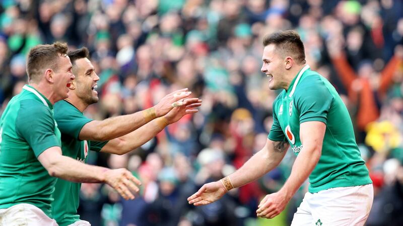 Ireland’s Jacob Stockdale celebrates his second try with Conor Murray and Chris Farrell at the Aviva Stadium. Photograph:  Tom Honan.