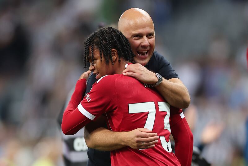 Rio Ngumoha is hugged by Liverpool manager Arne Slot after he had scored the late-winning goal against Newcastle. Photograph: Daniel Chesterton/Offside/Offside via Getty