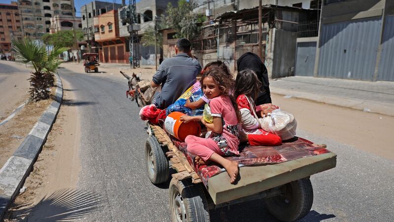 Members of a Palestinian family flee Israeli air and artillery strikes on a carriage pulled by a donkey in Beit Lahya in the northern Gaza Strip. Photograph: Mohammed  Abed/AFP via Getty