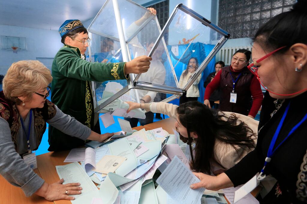 Members of a local electoral commission empty a ballot box at a polling station after parliamentary elections in Almaty, Kazakhstan, on Sunday. Photograph: Ruslan Pryanikov/AFP/Getty