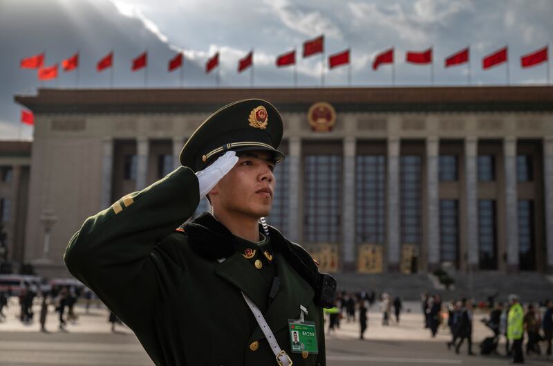 A member of the People's Armed Police salutes as delegates leave after the closing session of the National People's Congress in Beijing. Photograph:  Kevin Frayer/Getty Images