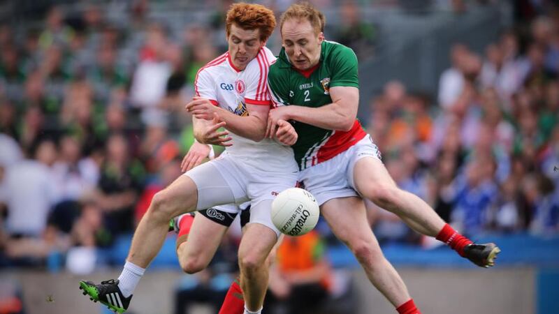Peter Harte of Tyrone (left) takes the shoulder hit from  Tom Cunniffe of Mayo that ended his game early at Croke Park. Photograph: Cathal Noonan/Inpho