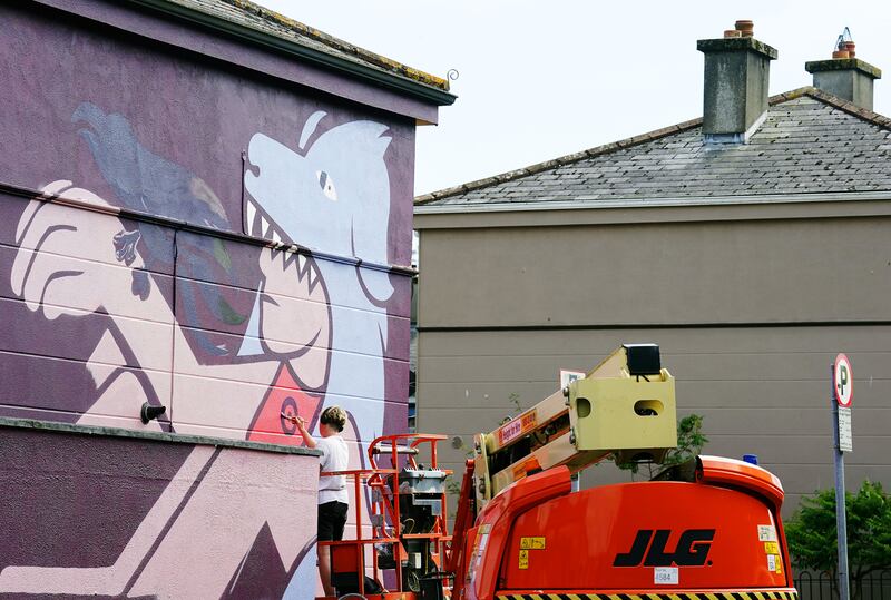 Scottish based street artist KMG works on a mural on Newport's Square, Waterford. Photograph: Brian Lawless/PA Wire