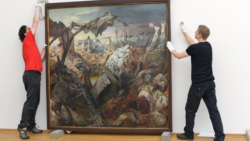 Staff members take down the triptych ‘Der Krieg’ (War) by Otto Dix, painted 1929-1932, in the Albertinum building at the Staatliche Kunstsammlungen for restoration on July 22, 2013 in Dresden, Germany. Photograph:  Matthias Rietschel/Getty Images)