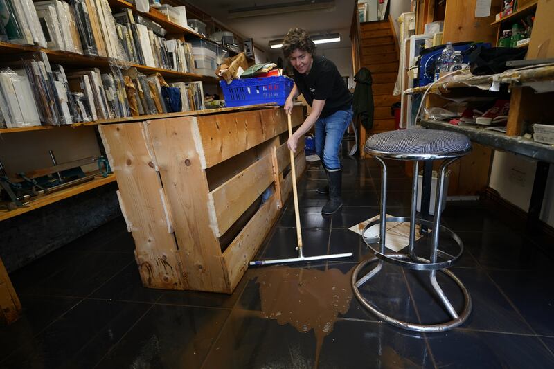 Shana Wilkie helps clean up her father's shop, Bernard Wilkie Jewellers, on Main Street. Photograph: Brian Lawless/PA Wire
