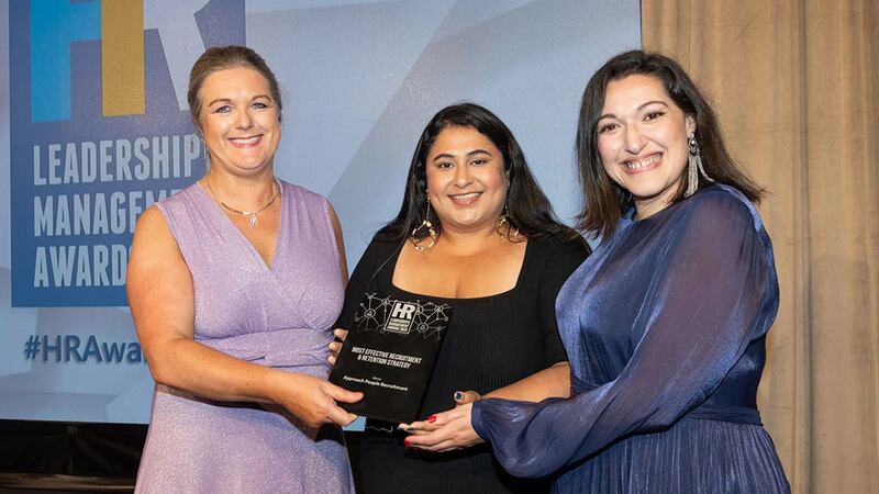 Rosarii Mannion, awards judge, presents the most effective recruitment & retention strategy award to Céline Ferhani and Aastha Trehan, Approach People Recruitment