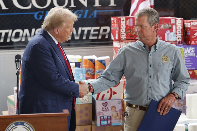 Donald Trump shakes hand with Georgia governor Brian Kemp in Evans after a news conference in the wake of damage caused in the state by Hurricane Helene. Photograph: Erik S Lesser/EPA-EFE