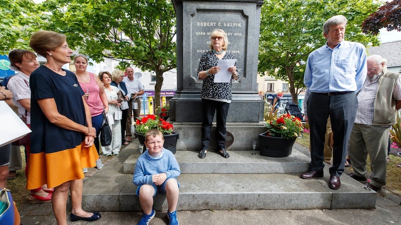 Guest of honour Marie Heaney, wife of the late Seamus,  speaking to the crowd at the Halpin Monument in Wicklow town with current owner, goldsmith Joan Gelletlie (left) and husband Richard (right). Photograph: Andres Poveda