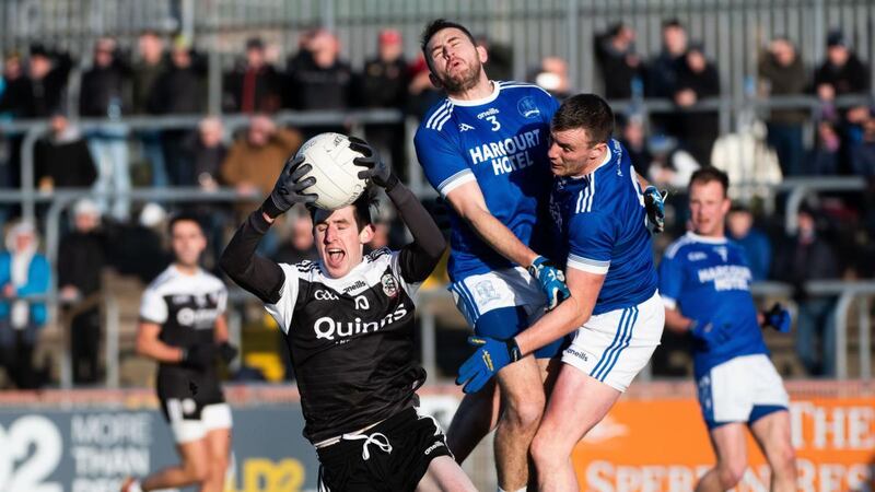 Kilcoo’s Eugene Branagan claims the ball as Naomh Conaill’s AJ Gallagher and Leo McLoone collide during the  AIB Ulster Club SFC Final  at Healy Park in Omagh. Photograph: Evan Logan/Inpho