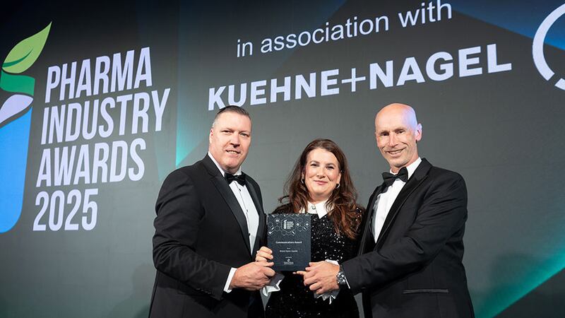 Greg Watson, business development manager at Tandem Project Management Ltd., presents the communications award to Keira Brogan and Padraig Landers, Bristol Myers Squibb