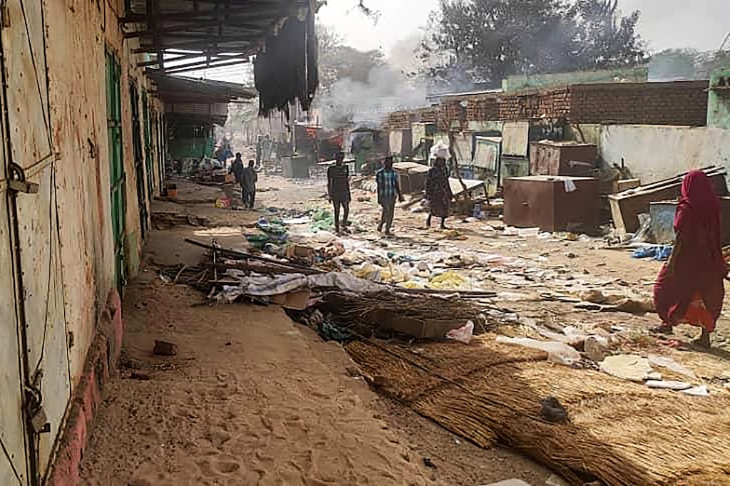 People walk among scattered objects in the market of El Geneina, the capital of West Darfur, during fighting in Sudan between the between the army and the paramilitary RSF, in April last year. Photograph: AFP via Getty Images
