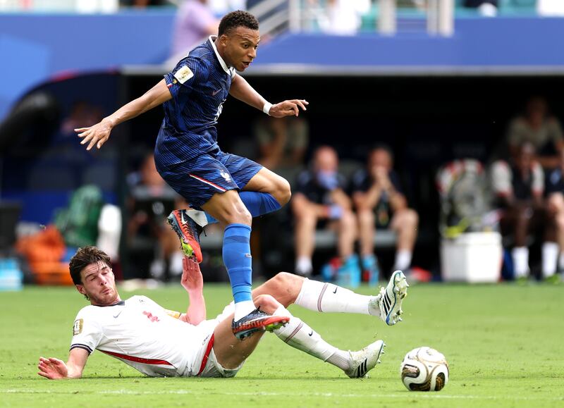 Kylian Mbappé of France is tackled by England's Declan Rice. Photograph: Kevin C Cox/Getty Images