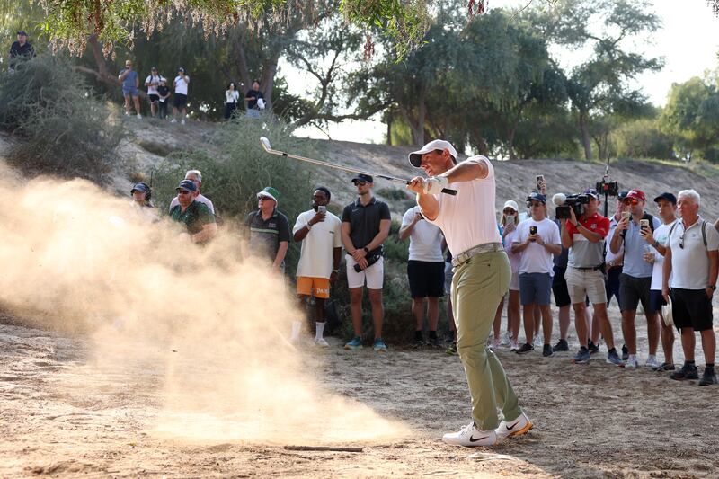 Rory McIlroy of Northern Ireland plays from the waste area on the 13th at Emirates Golf Club. Photograph: Richard Heathcote/Getty
